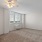 a room with a window and ceiling fan